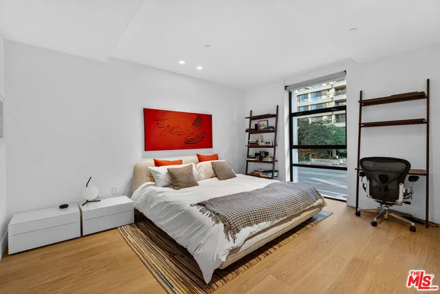 a bedroom with a bed and a chair