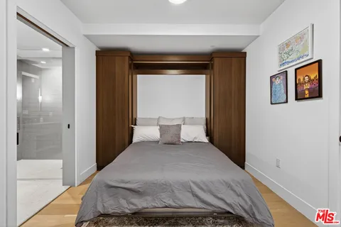 a bathroom with a bathtub shower sink mirror and toilet
