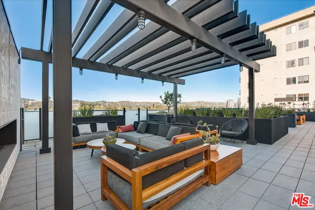 a view of a patio with table and chairs and potted plants