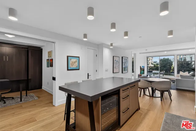 a kitchen with a table chairs and wooden floor