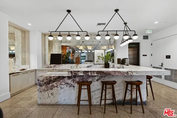 a living room with furniture and kitchen view