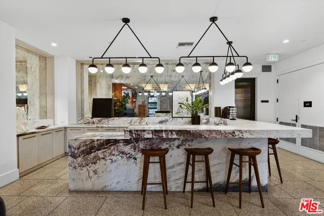 a living room with furniture and kitchen view