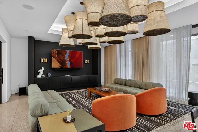 a living room with furniture a rug and a floor to ceiling window