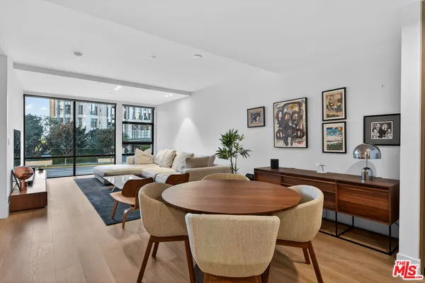 a dining room with furniture and a large window