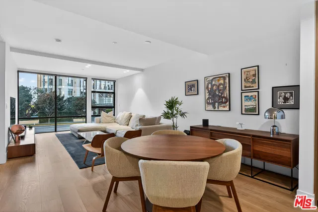 a dining room with furniture and a large window