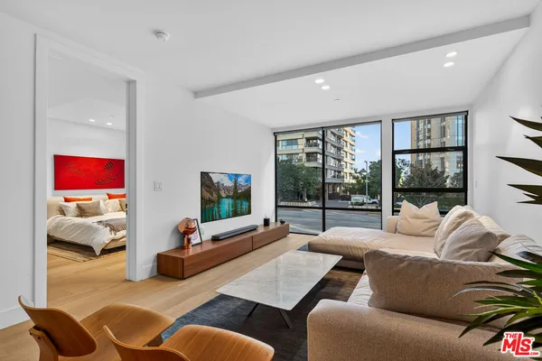 a living room with furniture large window and a flat screen tv