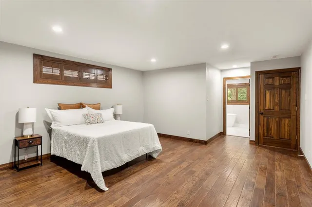 a bedroom with a bed and a table