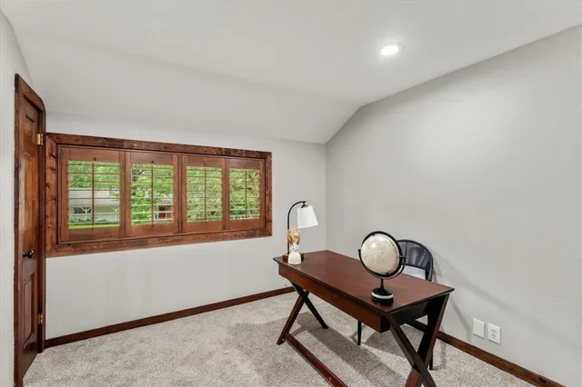 a view of a work space with furniture and window