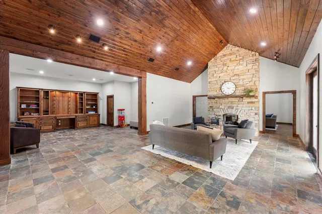 a living room with fireplace furniture and a large window