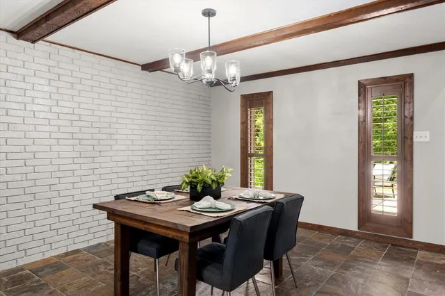 a view of a dining room with furniture and window