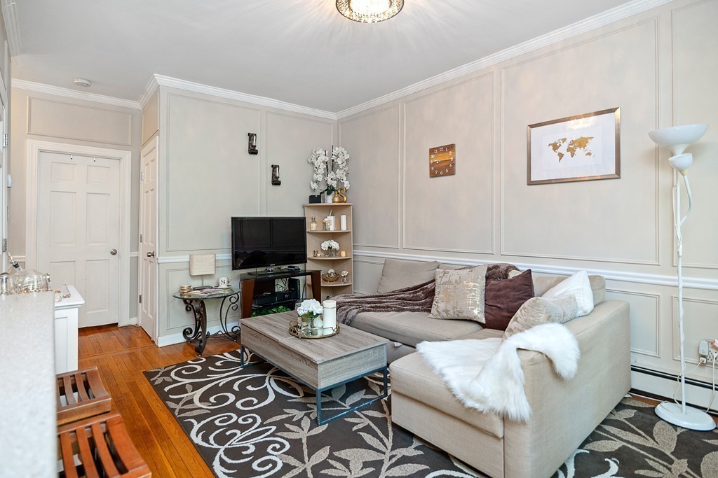 8 Lindall Place, Unit 2 Boston, MA 02114 - Photo 3 of 21 a living room with furniture and a flat screen tv