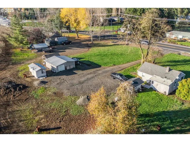 an aerial view of a house with a yard