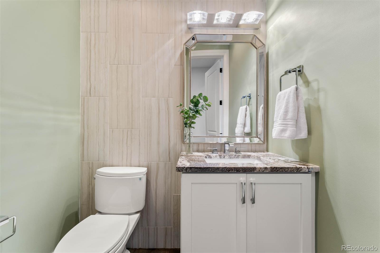1645 South Cook Street Denver, CO 80210 - Photo 26 of 48 a bathroom with a granite countertop sink mirror and toilet