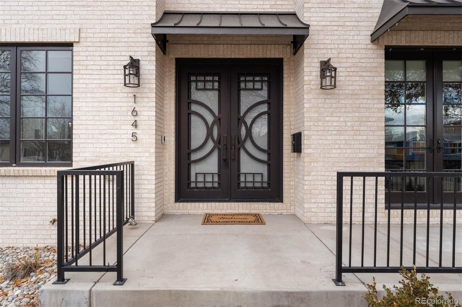 1645 South Cook Street Denver, CO 80210 - Photo 3 of 48 a front view of a house with a gate