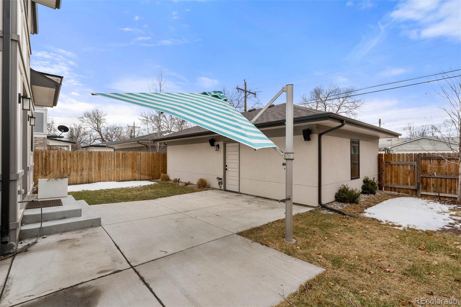 1645 South Cook Street Denver, CO 80210 - Photo 45 of 48 a view of a house with backyard and parking space
