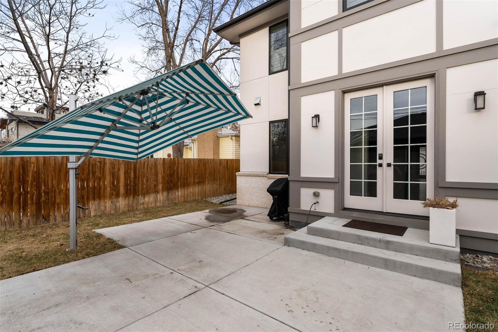 1645 South Cook Street Denver, CO 80210 - Photo 46 of 48 a front view of a house with a yard