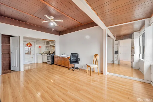 a view of a room with lots of wooden furniture