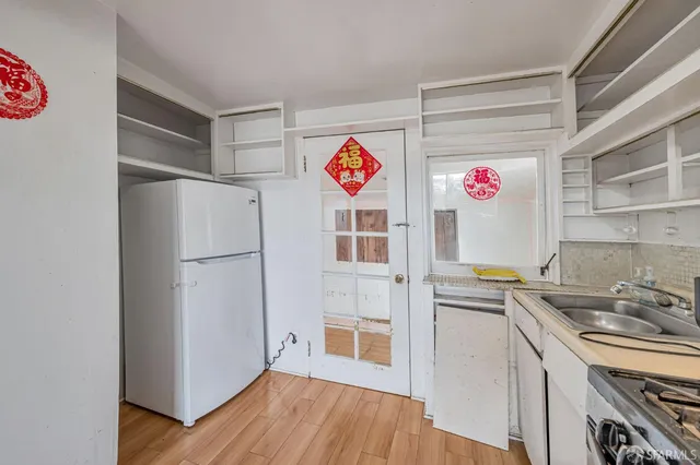 a kitchen with a refrigerator and a sink