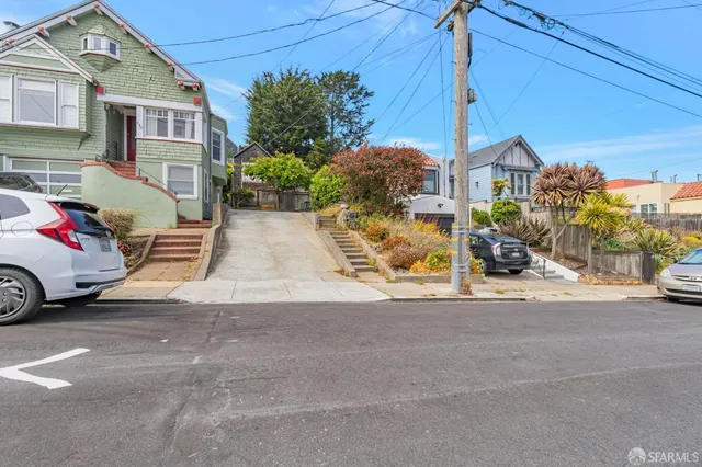 a view of a car park in front of house