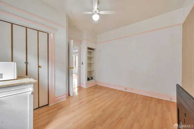 wooden floor in an empty room with a window