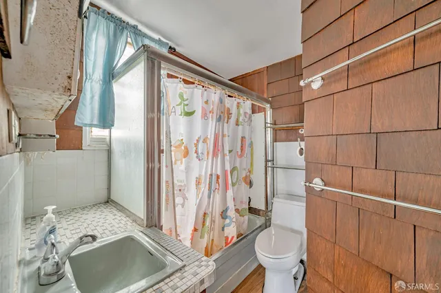a bathroom with a sink toilet and shower
