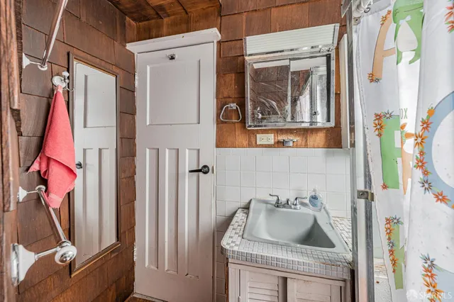 a bathroom with a sink a toilet and a mirror