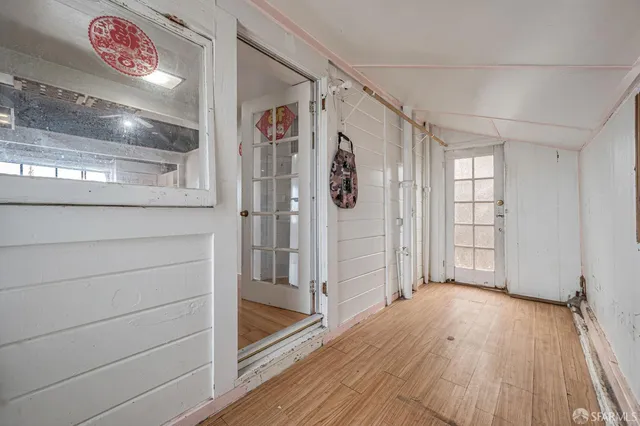 a view of empty room with wooden floor