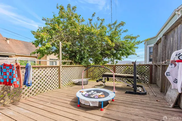 a outdoor space with patio the couches and a dining table with wooden fence
