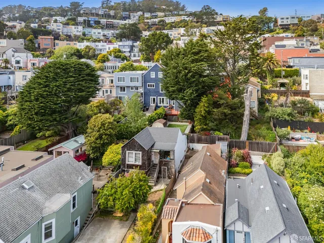 an aerial view of residential houses with outdoor space