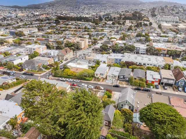 an aerial view of residential houses with city view