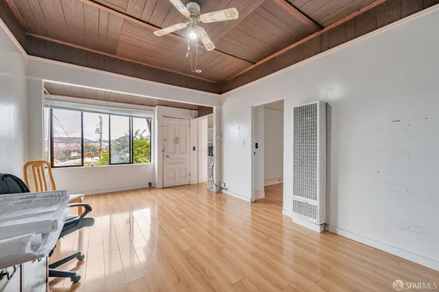 a view of a livingroom with furniture hardwood floor and a ceiling fan