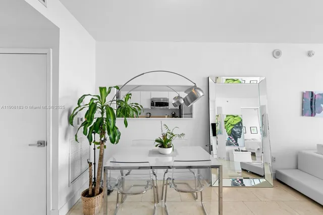 a living room with furniture potted plant and a chandelier