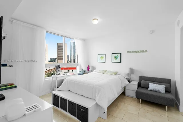 a bedroom with a bed and a couch