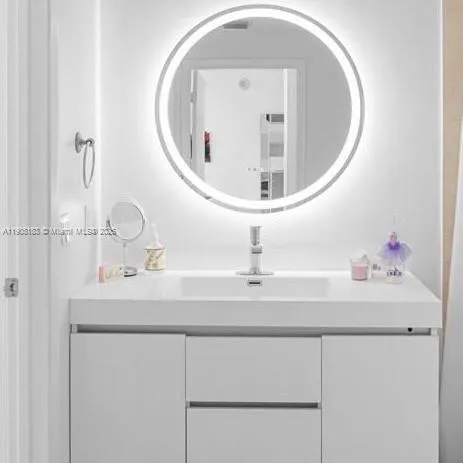 a bathroom with a sink and mirror
