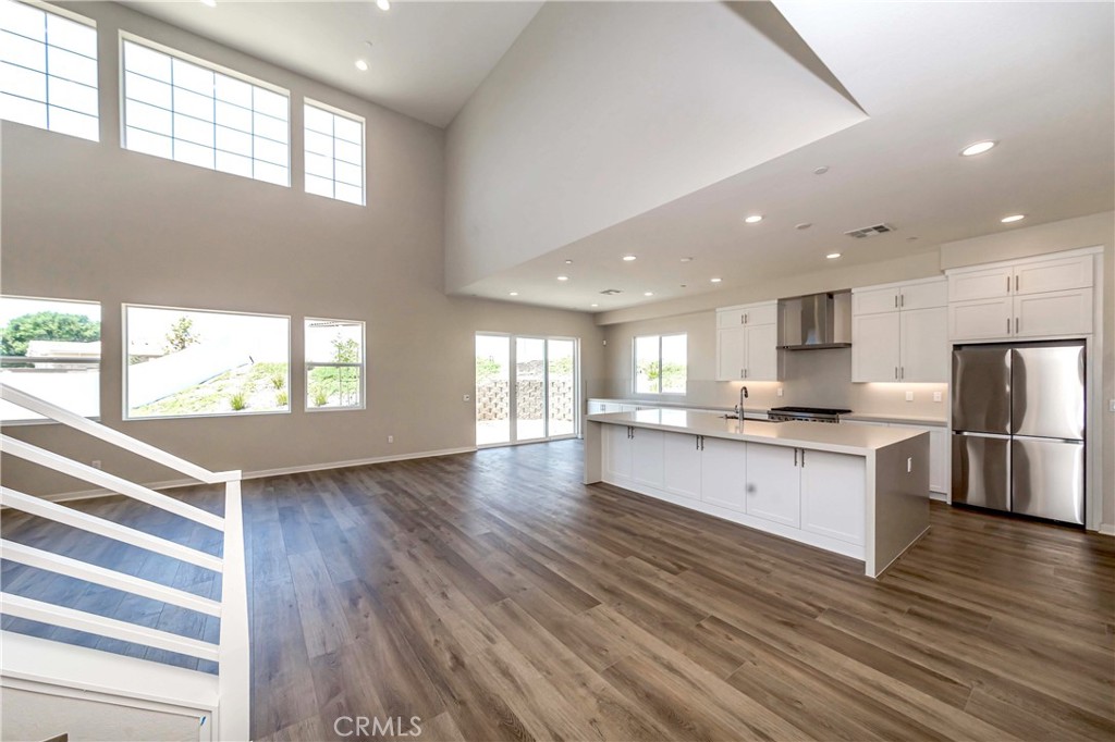 6521 Canyon Oaks Drive Simi Valley, CA 93063 - Photo 12 of 39 a large kitchen with stainless steel appliances granite countertop a lot of counter space and wooden floor