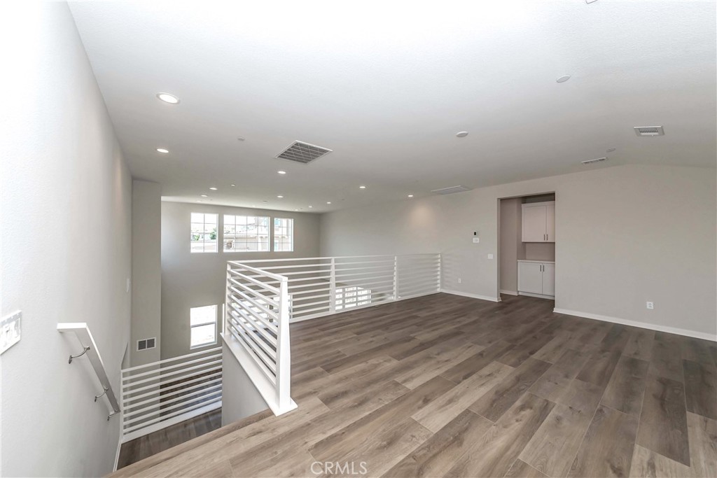6521 Canyon Oaks Drive Simi Valley, CA 93063 - Photo 20 of 39 a view of an empty room with wooden floor and windows