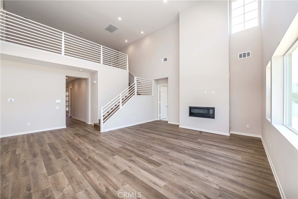 6521 Canyon Oaks Drive Simi Valley, CA 93063 - Photo 4 of 39 a view of an empty room with wooden floor and a window