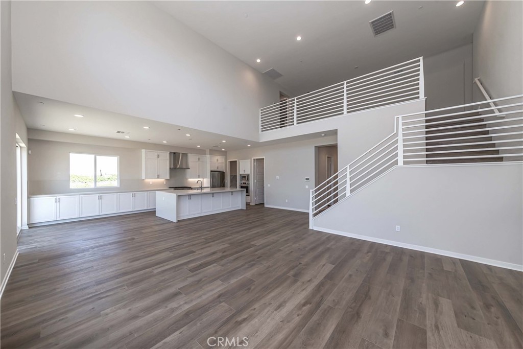 6521 Canyon Oaks Drive Simi Valley, CA 93063 - Photo 6 of 39 a view of empty room with wooden floor and kitchen