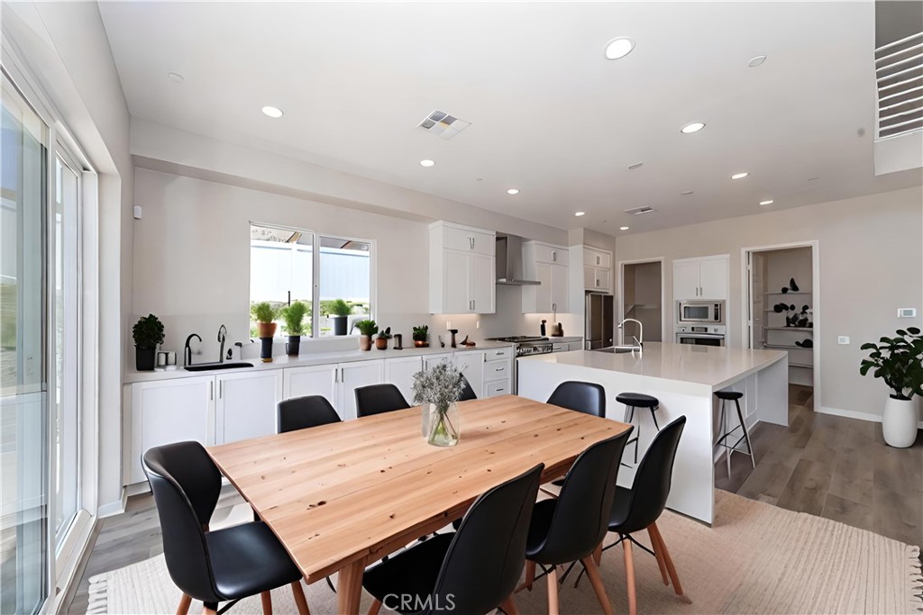 6521 Canyon Oaks Drive Simi Valley, CA 93063 - Photo 8 of 39 a view of a dining room with furniture and wooden floor