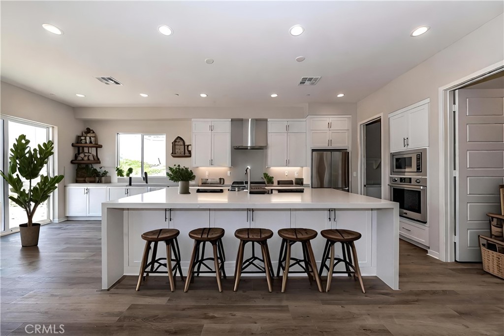 6521 Canyon Oaks Drive Simi Valley, CA 93063 - Photo 9 of 39 a large kitchen with a table and chairs in it