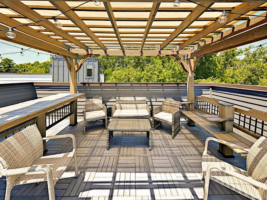 a roof deck with couches and wooden floor