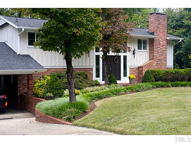 5009 Raintree Court Raleigh, NC 27609 - Photo 1 of 23 a front view of a house with garden