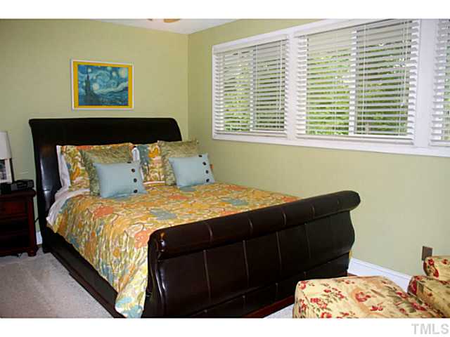 5009 Raintree Court Raleigh, NC 27609 - Photo 14 of 23 a bedroom with a bed and a window