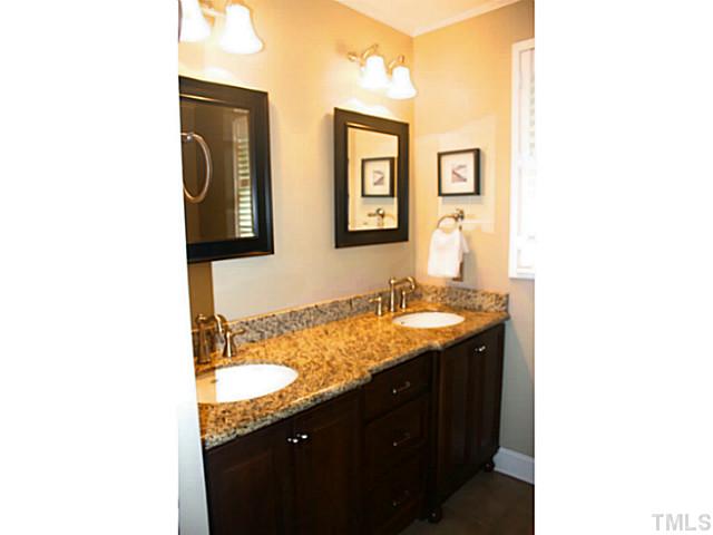 5009 Raintree Court Raleigh, NC 27609 - Photo 16 of 23 a bathroom with a granite countertop sink and a mirror