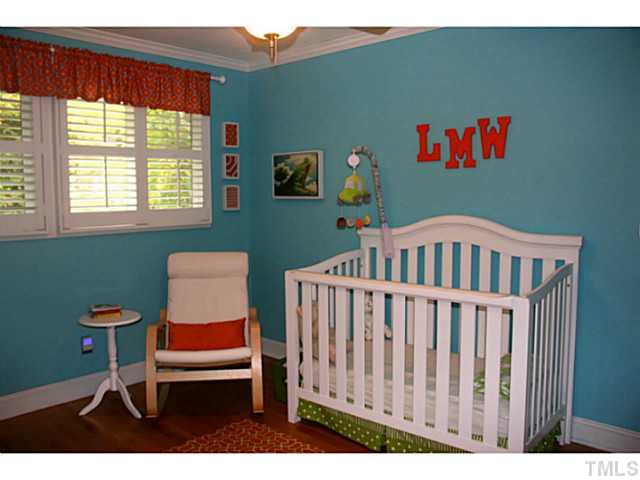 5009 Raintree Court Raleigh, NC 27609 - Photo 18 of 23 a bedroom with a bed and a window