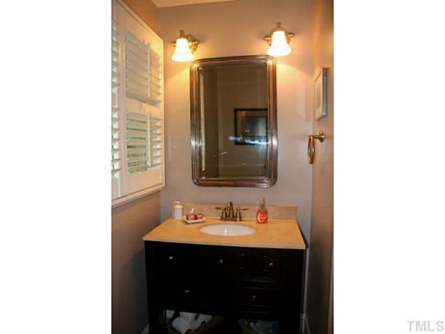5009 Raintree Court Raleigh, NC 27609 - Photo 19 of 23 a bathroom with a sink and a mirror