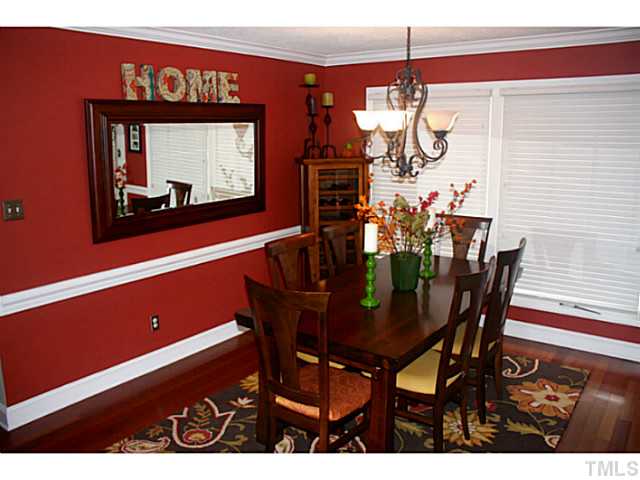 5009 Raintree Court Raleigh, NC 27609 - Photo 7 of 23 a view of a dining room with furniture and wooden floor