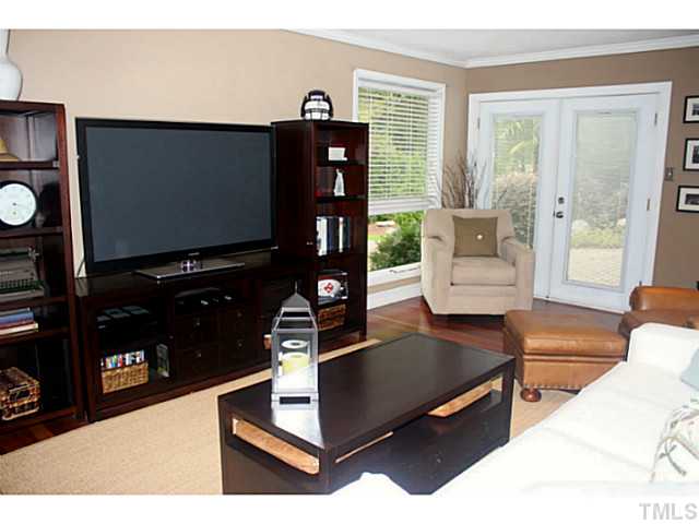 5009 Raintree Court Raleigh, NC 27609 - Photo 9 of 23 a living room with furniture and a flat screen tv