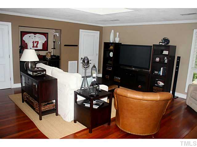 5009 Raintree Court Raleigh, NC 27609 - Photo 10 of 23 a living room with furniture and a flat screen tv