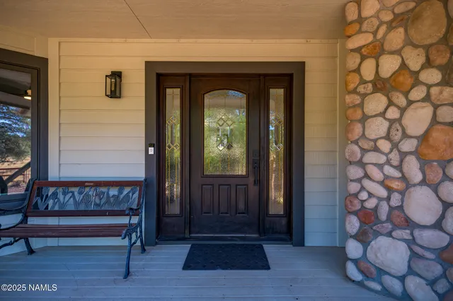 a view of entryway with wooden floor and a front door